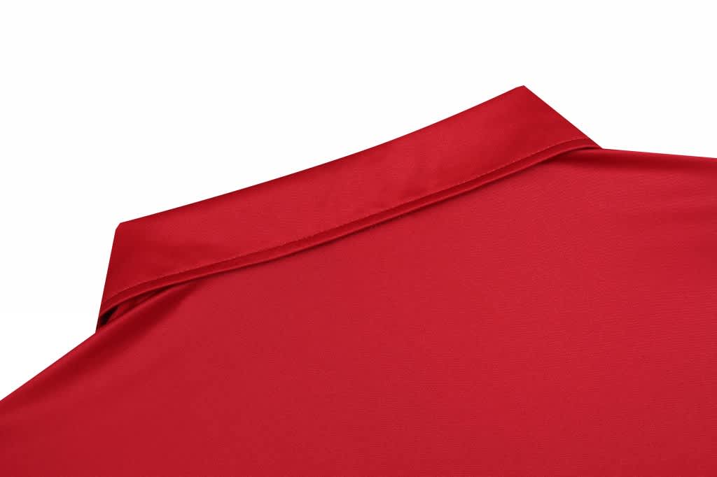 A red shirt featuring a collar, displayed on a white background, showcasing the fabric's texture.