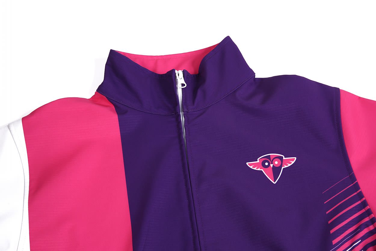 A softshell deck coat in vibrant purple and pink, featuring a branding logo on the chest.