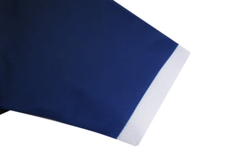 A pair of ice hockey shorts in navy blue with a white trim at the hem. Includes a logo on the garment.