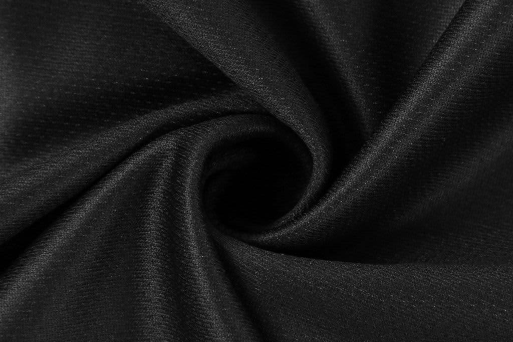 A black fabric with a smooth texture, featuring a subtle pattern and a slight sheen.