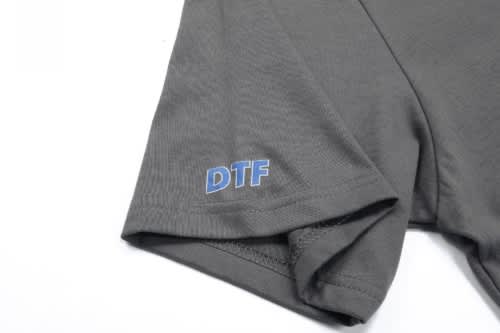 A grey cotton T-shirt featuring a small logo on the sleeve, labelled "DTF".