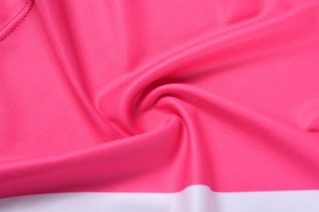 A close-up of a vibrant pink fabric with a smooth texture, featuring a white horizontal stripe. The image includes a logo.