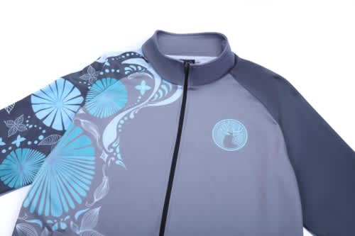A grey jacket featuring stylish blue patterns and a logo, designed for school wear and sports uniforms.