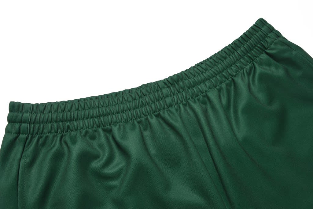 A pair of green sweatpants with an elastic waistband, featuring a smooth fabric texture.