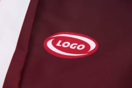 A maroon sports uniform featuring a logo, with white detailing on the side.
