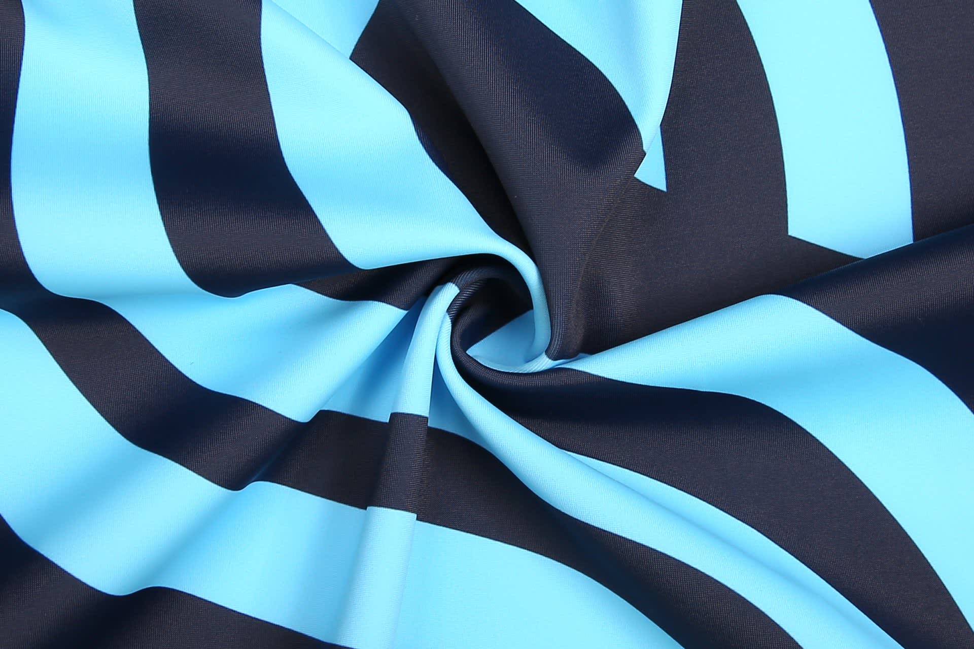 A close-up of a fabric featuring alternating black and light blue stripes, suitable for sports uniforms.