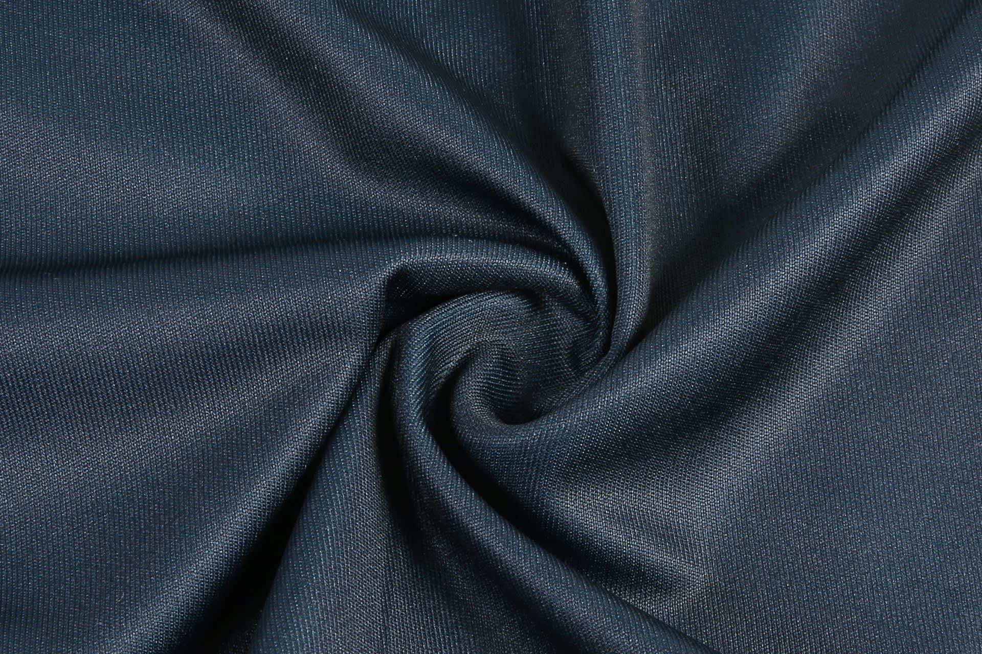 A swirl of dark navy fabric, showcasing a smooth and textured surface. Features a subtle sheen.