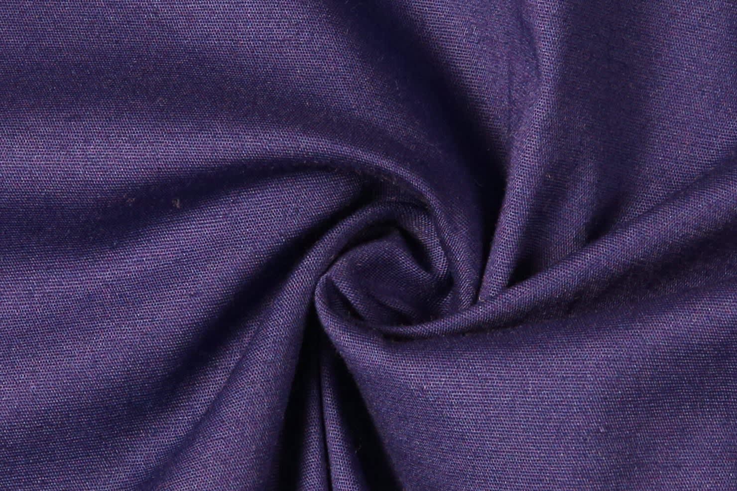 A swirl of textured fabric in deep purple, showcasing a smooth and woven surface.