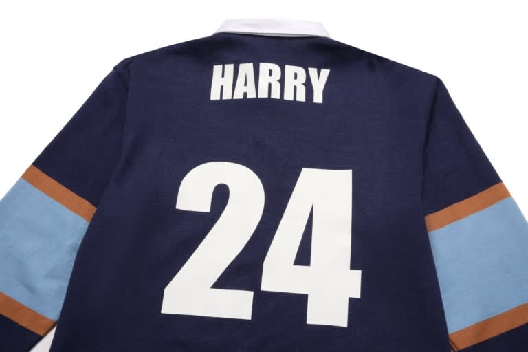A navy sports jumper featuring brown and light blue stripes with a large white number 24 and a name.