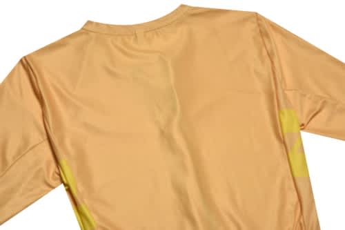 A yellow sports jersey with long sleeves, featuring a logo on the back.