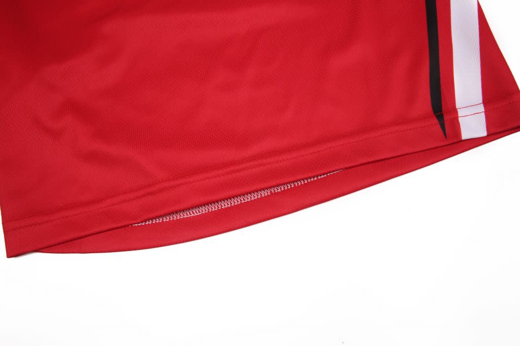 A pair of red uniform shorts with a black and white design along the side. Features a smooth, lightweight fabric.