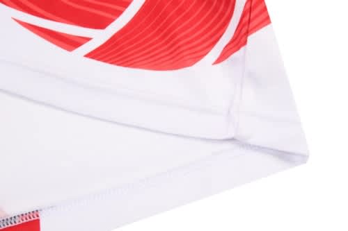 A volleyball uniform featuring a white base with red graphic patterns, including a logo.