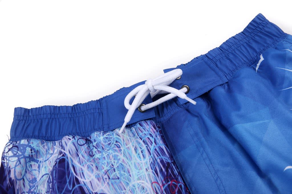 Blue and patterned board shorts feature a drawstring waistband and an elasticated back. The fabric has a logo.