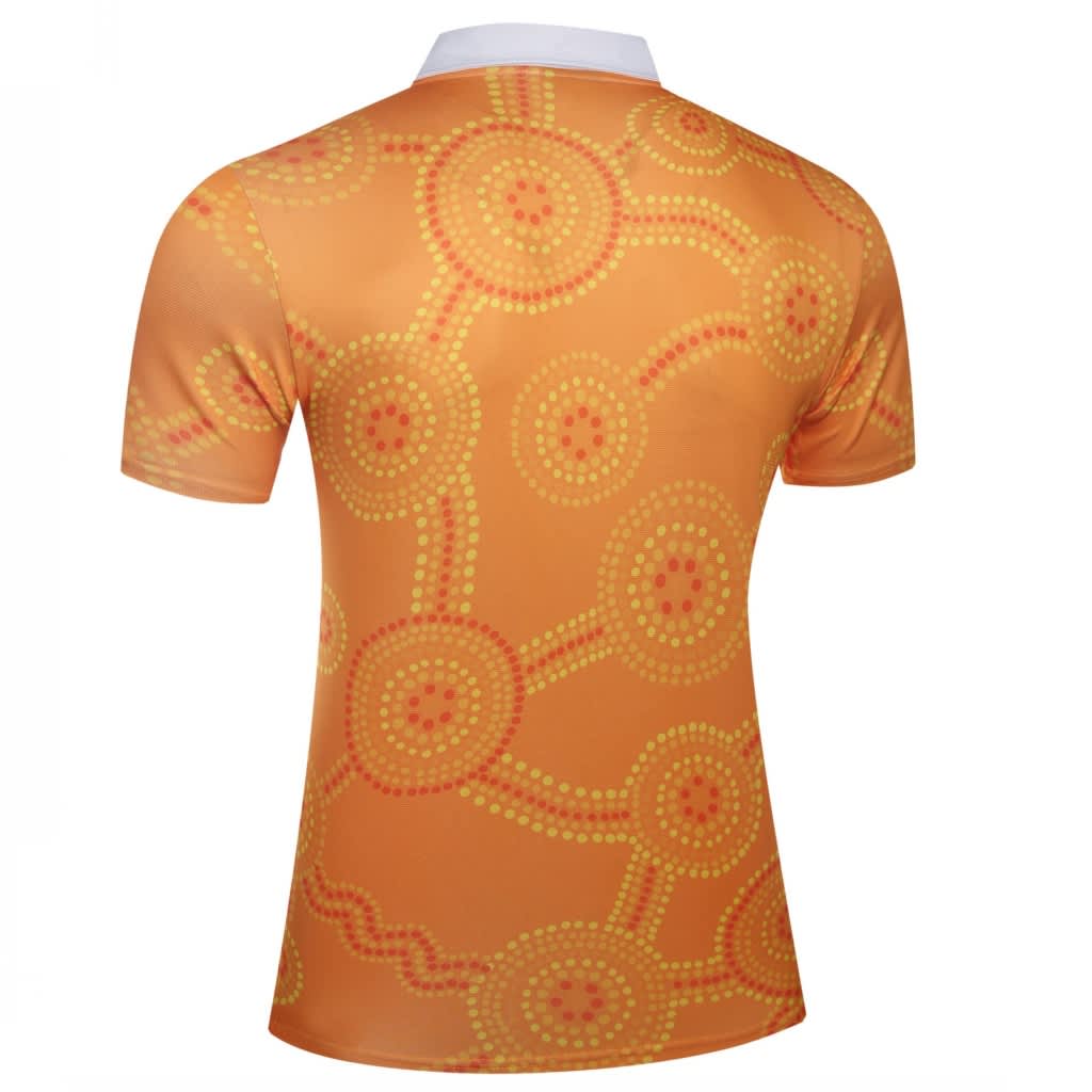 A short-sleeved shirt featuring an orange design with circular dot patterns and a white collar. It has a logo.
