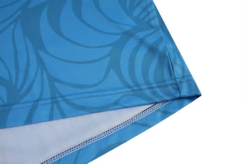 A blue volleyball uniform featuring a patterned design and a smooth finish. It has a logo on the fabric.