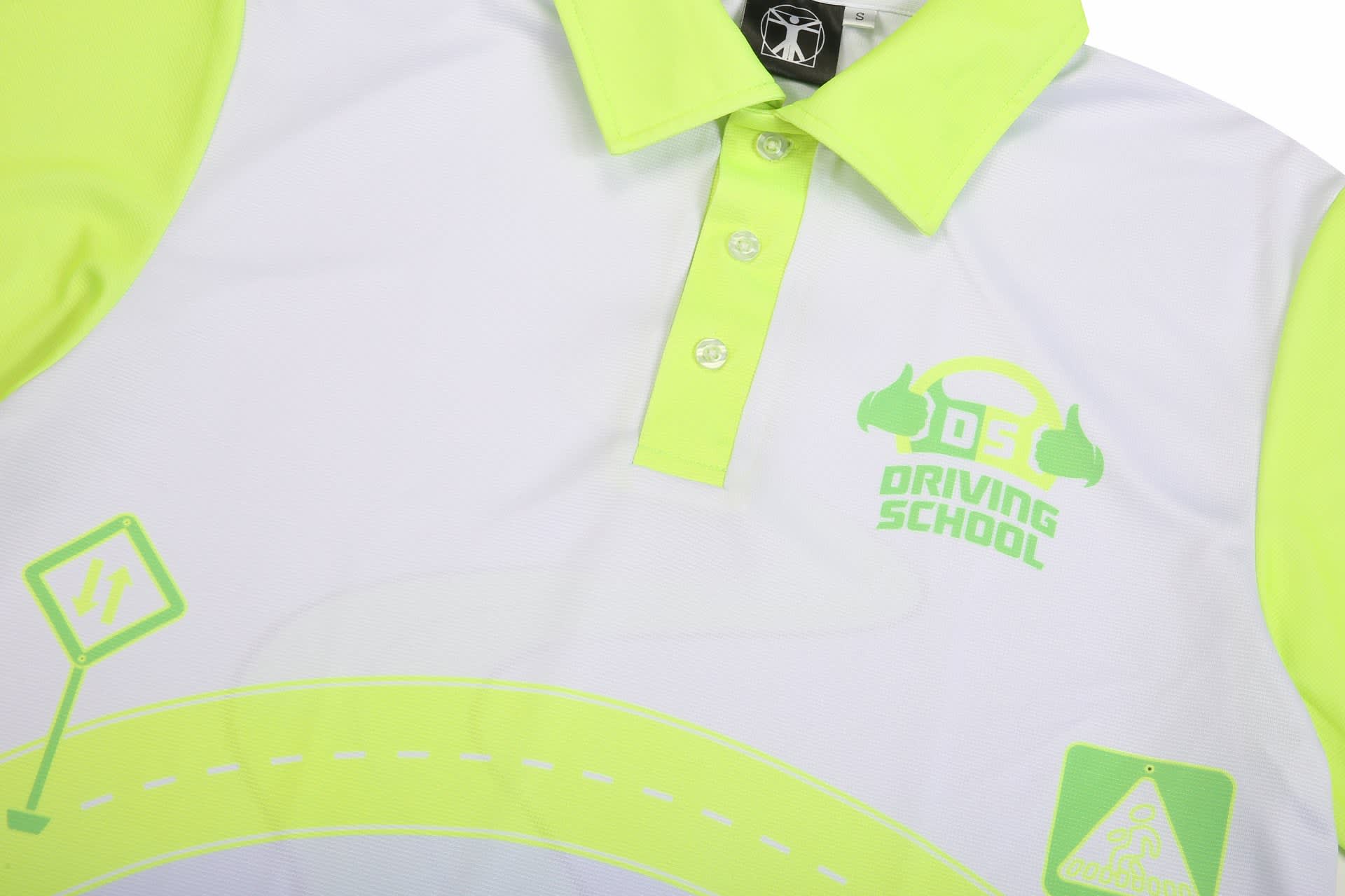 A bright yellow and white driving school polo shirt featuring a logo and graphic elements related to driving.