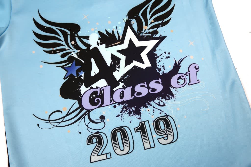 A light blue polo featuring graphic designs, including stars and wings, with the text "Class of 2019." It has a logo.
