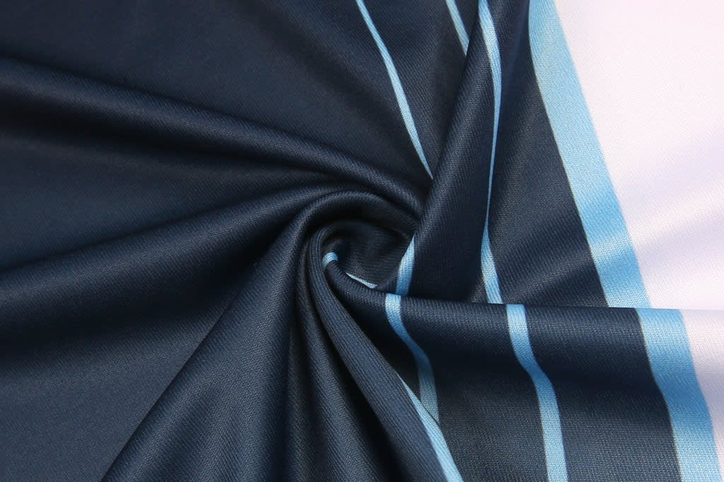 A fabric with a navy blue base and light blue stripes, arranged in a swirling pattern. It has a smooth texture.