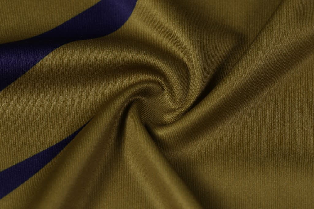 A swirl of fabric in olive green with navy blue accents. The material is smooth and lightweight, suitable for apparel.