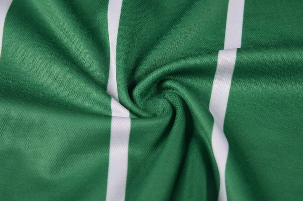 A green fabric featuring white stripes, displaying a smooth, circular design. Suitable for sports uniforms.