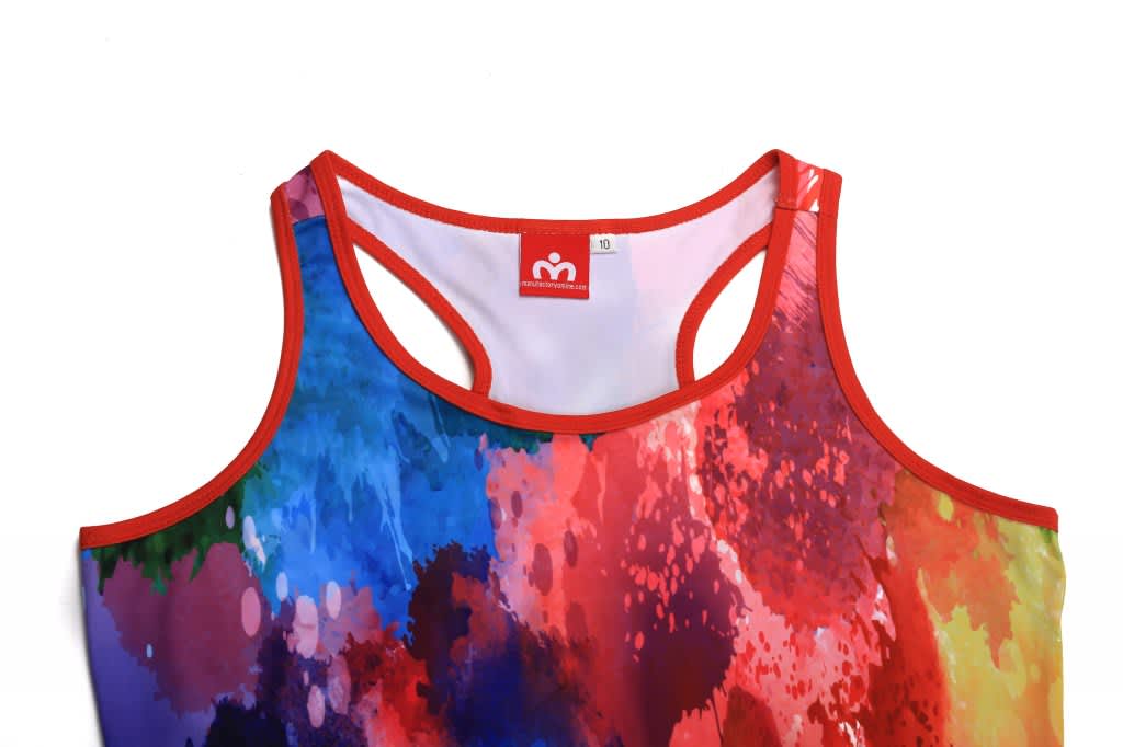 A colourful fitness singlet with a red trim featuring a vibrant splash of blues, reds, and yellows. Includes a logo.