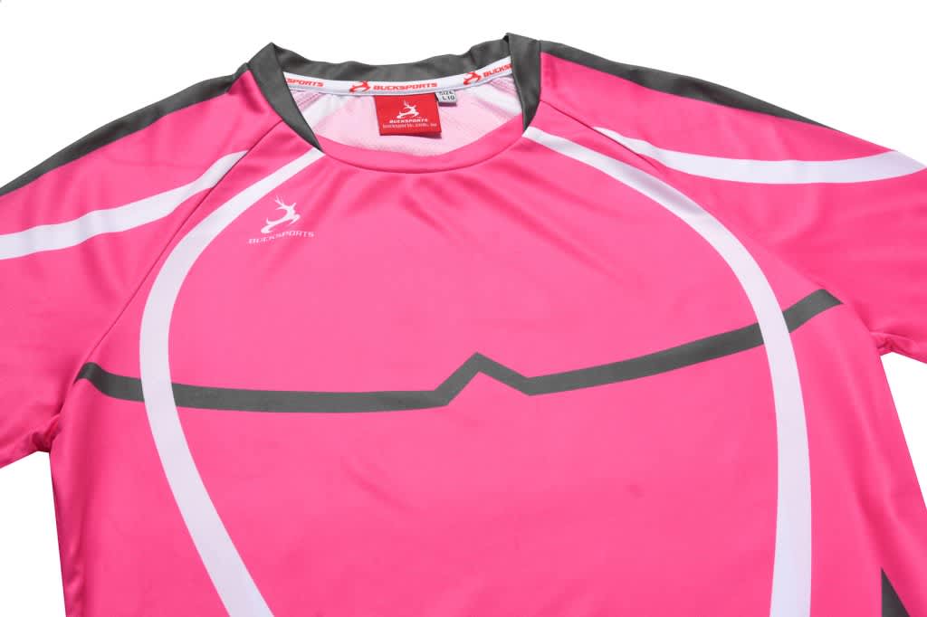 A pink athletic t-shirt with grey detailing and a branding logo on the collar.