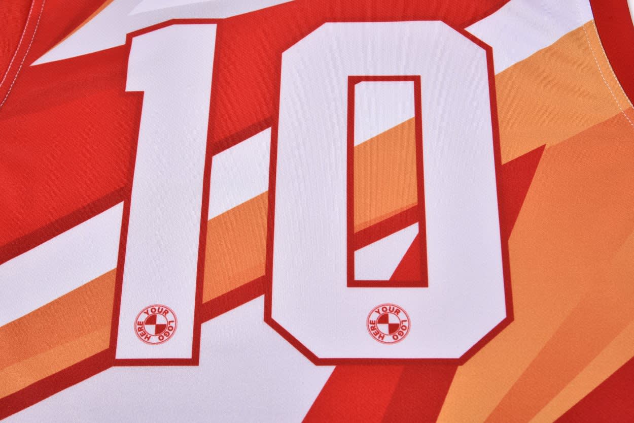 A red and orange Australian rules football jersey featuring the number 10 and a logo.