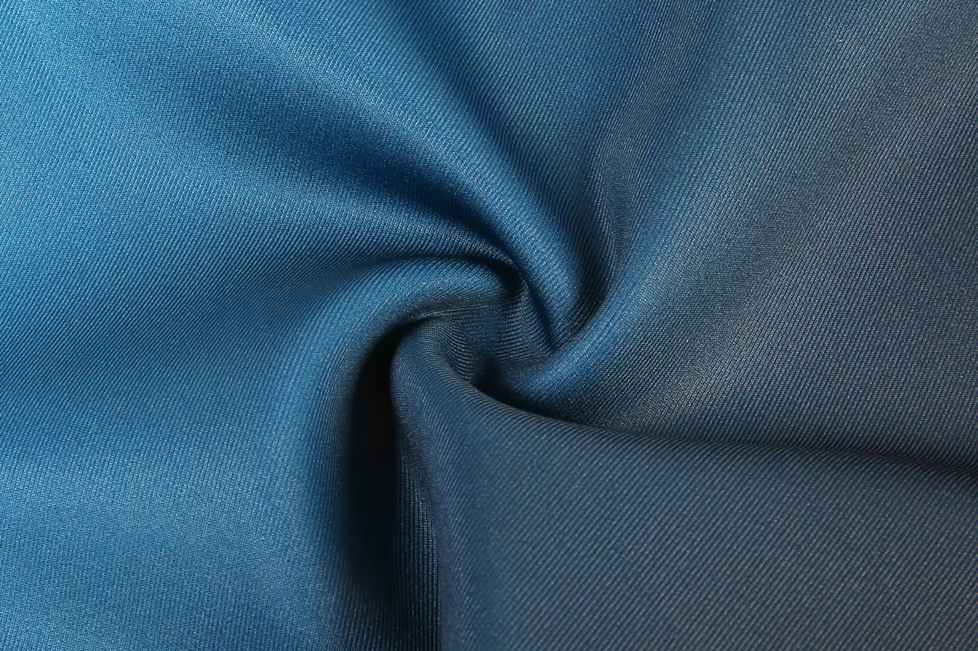 A close-up of blue fabric showing a smooth, textured surface, ideal for rugby uniform shorts.