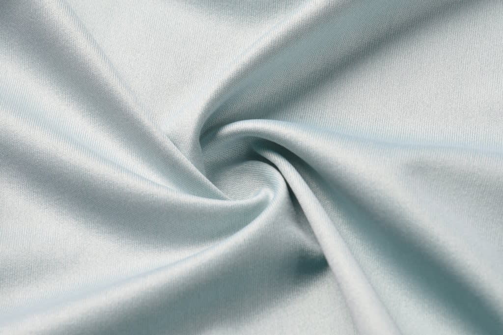 A close-up of light blue satin fabric, showcasing its smooth texture and sheen.