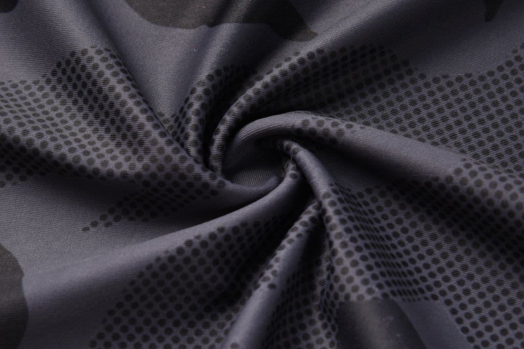 A black and grey patterned fabric featuring dots and a camouflage design, suitable for sublimation printing.