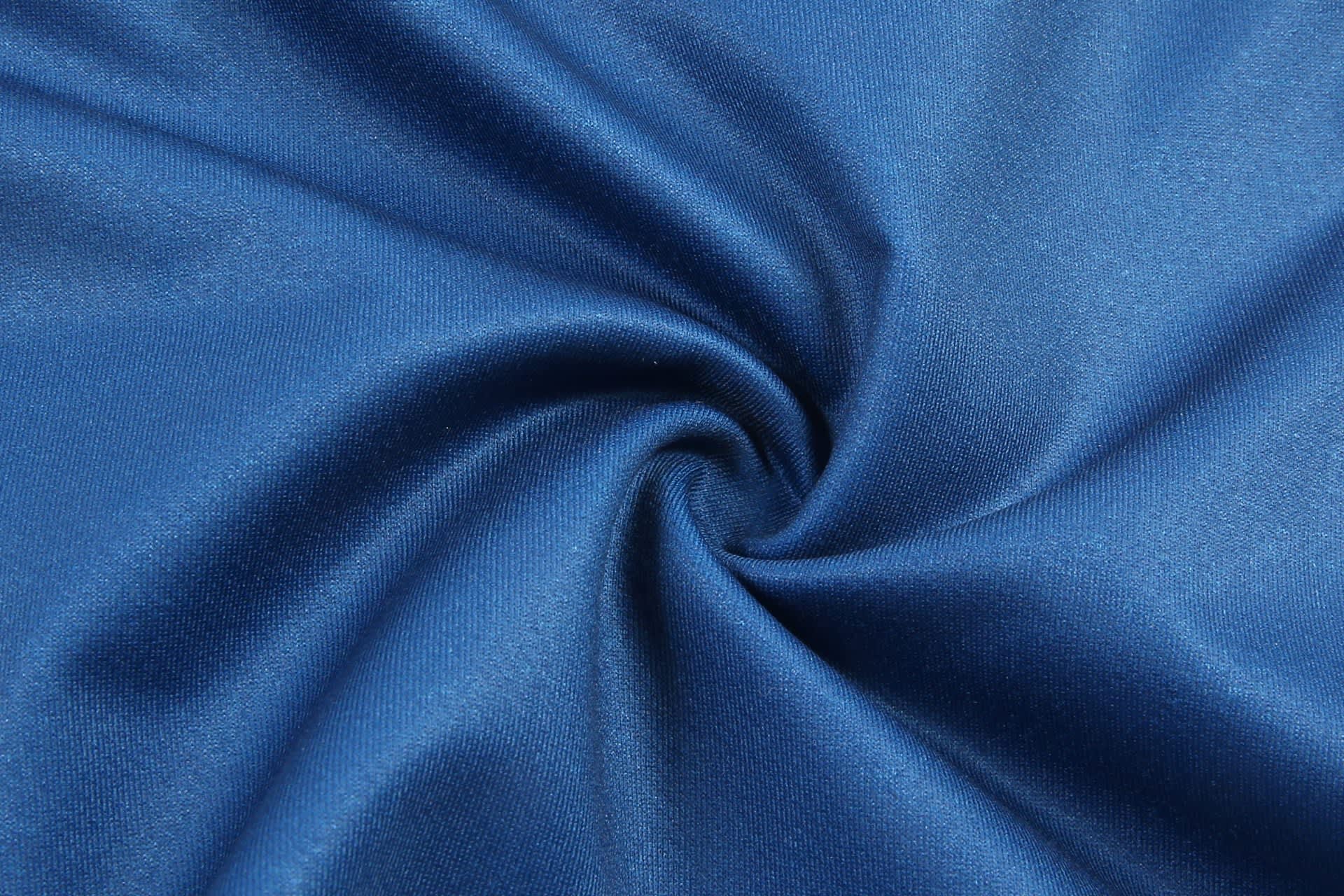 A blue fabric swatch with a smooth texture, arranged in a spiral pattern. The material appears lightweight and flexible.
