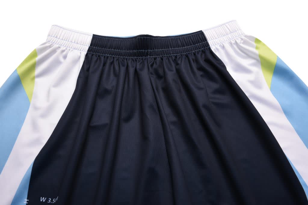Sport shorts in navy blue with light blue and green accents, featuring an elastic waistband and branding present.