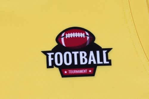 A bright yellow sports singlet featuring a football logo and a branding patch.