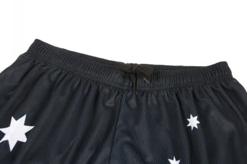 Black sports shorts featuring white star patterns and an elastic waistband. Includes a logo or branding element.
