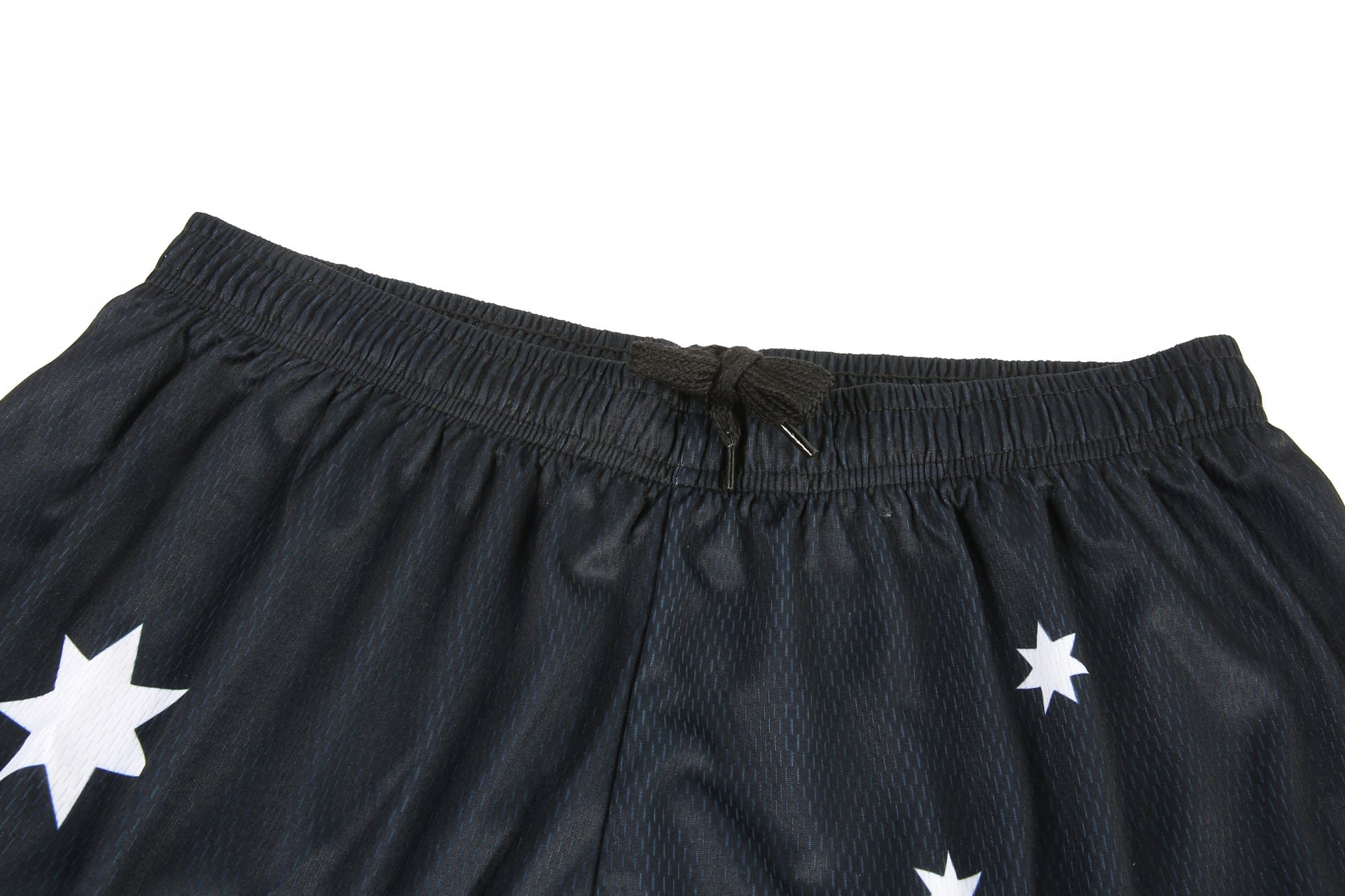 Black soccer shorts featuring white star designs with an elastic waistband and drawstring.