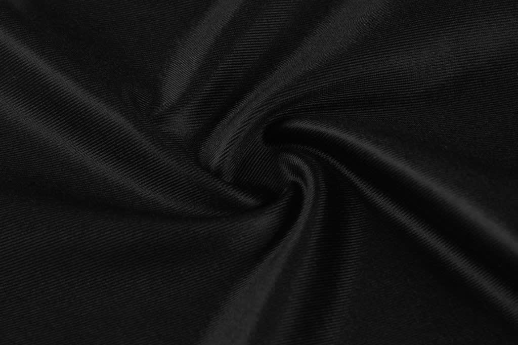 A close-up of black fabric with a smooth, shiny texture, showcasing its soft sheen and flowing folds.