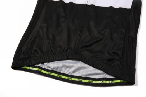 A black cycling jersey featuring a mesh fabric and a lime green interior lining, with an understated logo.