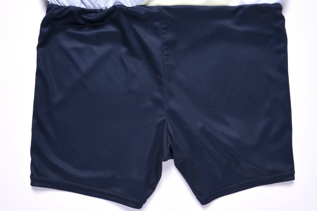 A navy blue skort featuring a smooth texture and a stylish design, with a logo on the waistband.