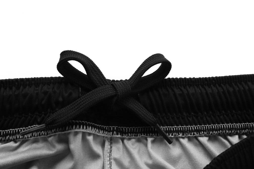 Black training shorts featuring a drawstring tie at the waistband and a smooth inner lining.