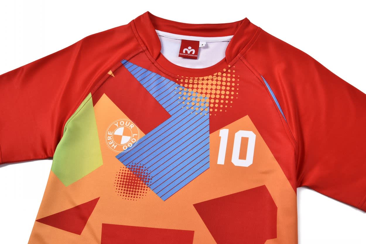A vibrant red and orange football jersey with geometric patterns and a logo. Features short sleeves and the number 10.