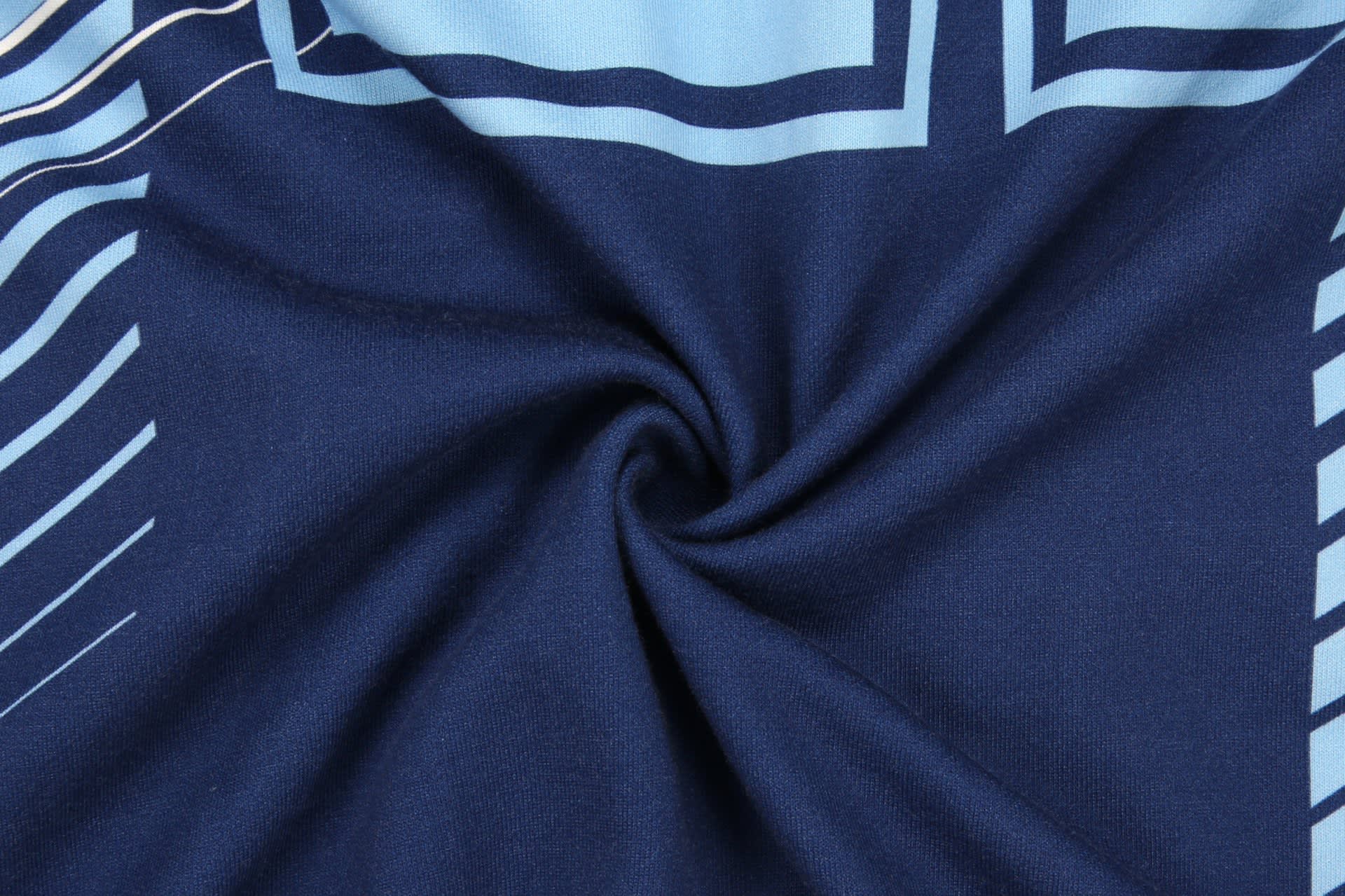 A navy blue hoodie featuring light blue geometric patterns and a branding logo.