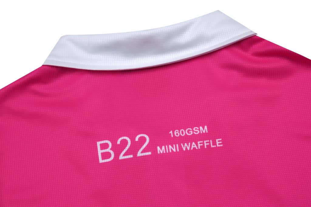 A pink women's polo shirt featuring a white collar and brand logo on the back.