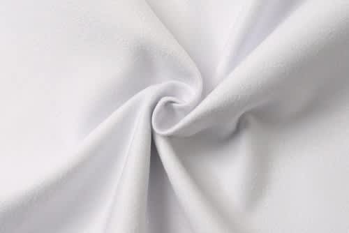 A folded white fabric with a smooth texture, featuring a gentle swirl at the centre.