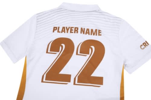 A white cricket uniform with brown accents, featuring the number 22 and a logo.