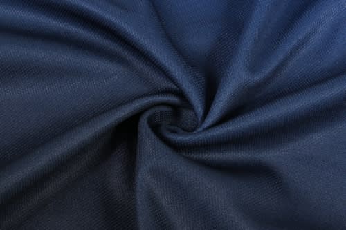 A close-up of navy fabric, featuring a textured weave, suitable for sports uniforms.