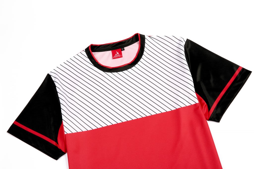 A red sportswear T-shirt with black sleeves and a striped white panel on the front, featuring a logo.