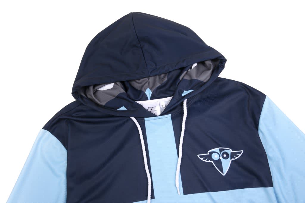 A blue and navy tank top hoodie with 3/4 long sleeves and a logo on the front.