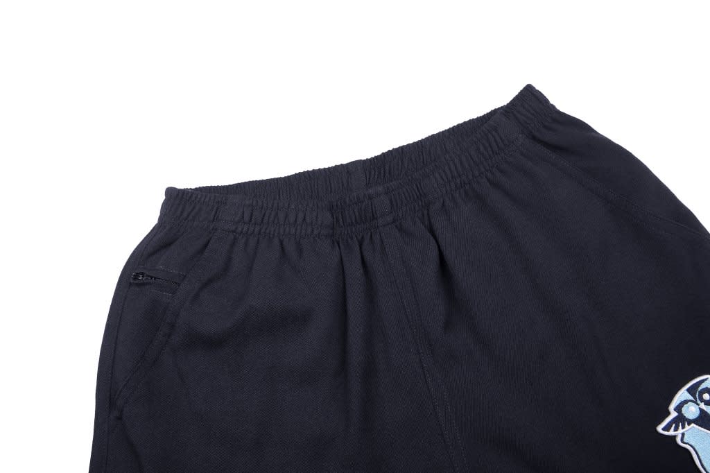 Black shorts featuring an elastic waistband and a side pocket, with an embroidered design on the leg.