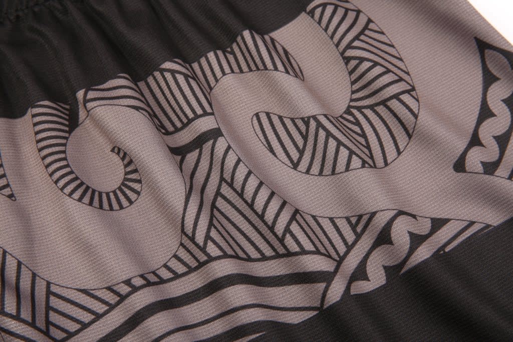 Aboriginal/Indigenous shorts featuring intricate black and grey patterns in a stylish design.