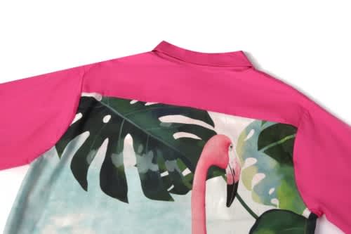 A pink sports jersey featuring a colourful flamingo and tropical leaf design on the back.